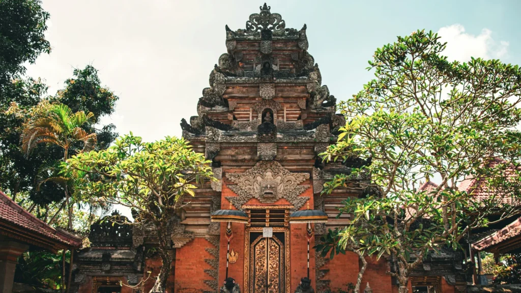Ulun Danu Beratan Temple at sunrise reflecting on calm lake water in Bali Indonesia