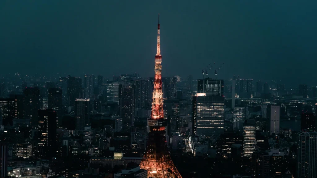 Tokyo skyline at night featuring Tokyo Tower illuminated above the city lights in Japan